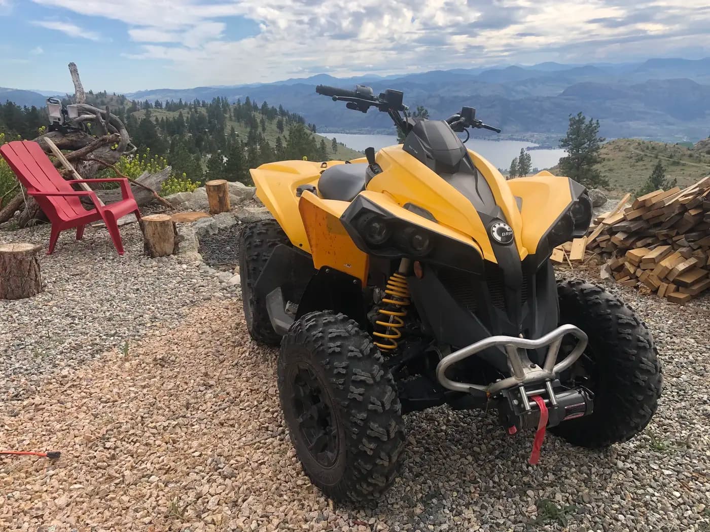 Yellow Can-Am ATV quad on Summit Retreat mountain property with Osoyoos Lake view