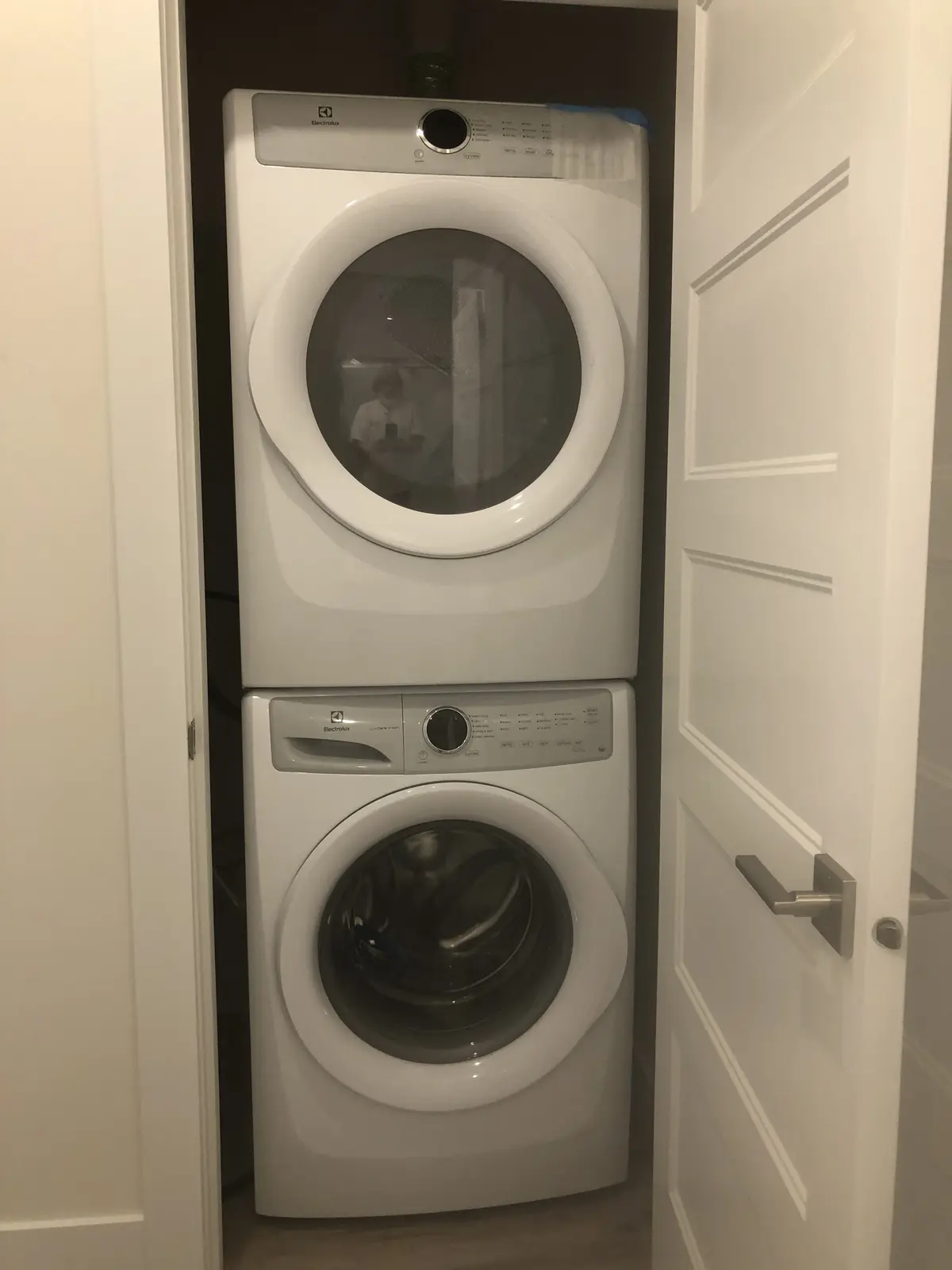 In-suite Electrolux stacked washer and dryer laundry closet at Aisha's Jewel