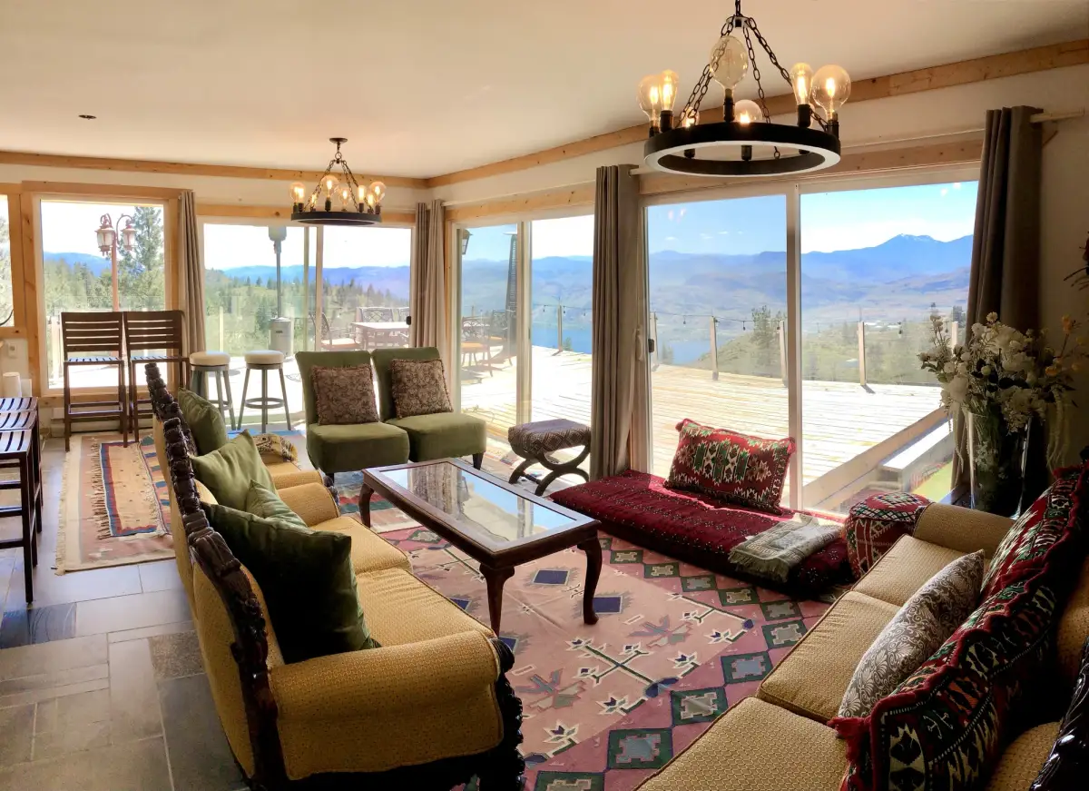 Wide angle view of Summit Retreat living room with lake views and sliding glass doors to deck