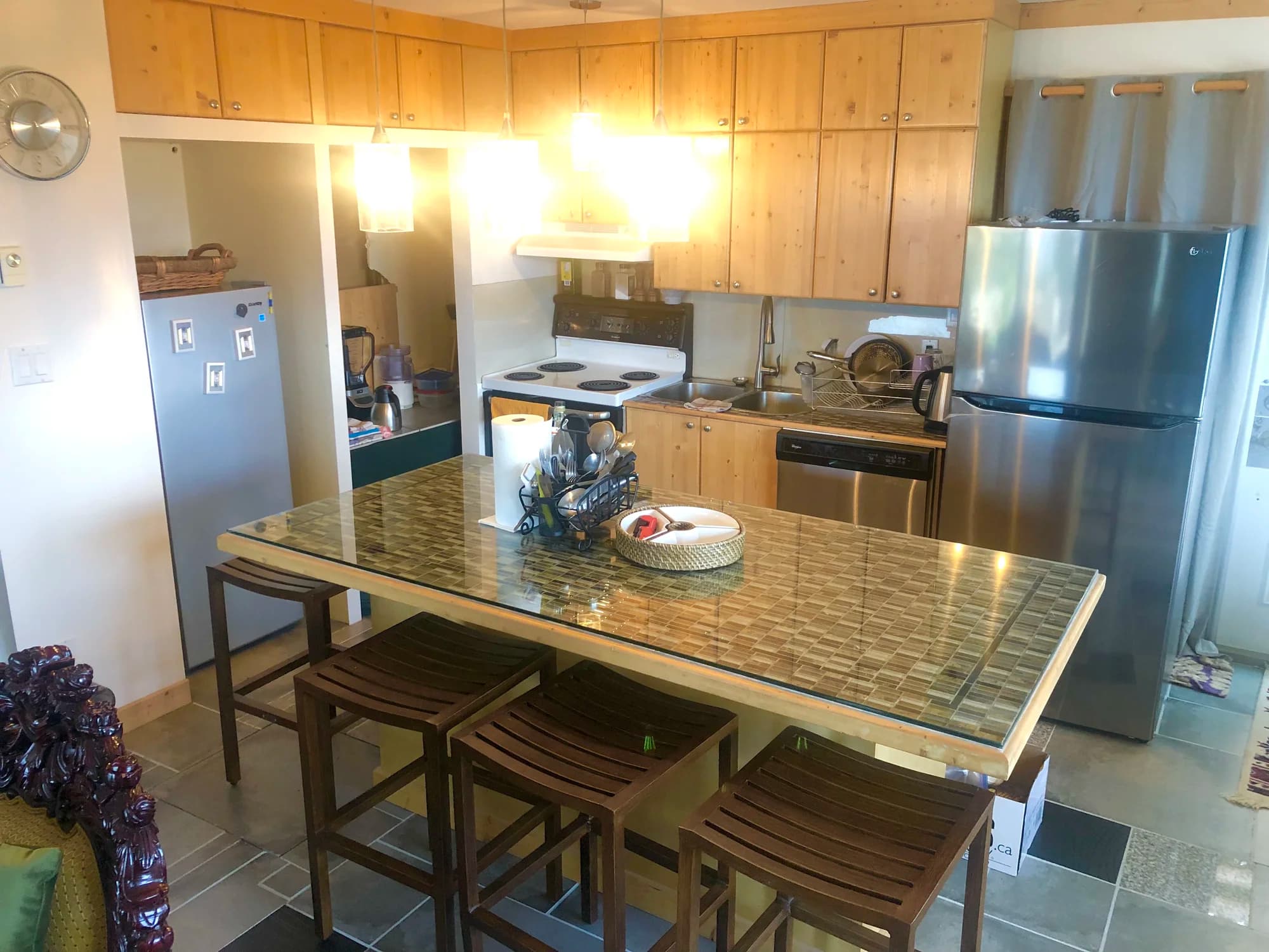 Summit Retreat kitchen with glass island, knotty pine cabinets and stainless steel appliances
